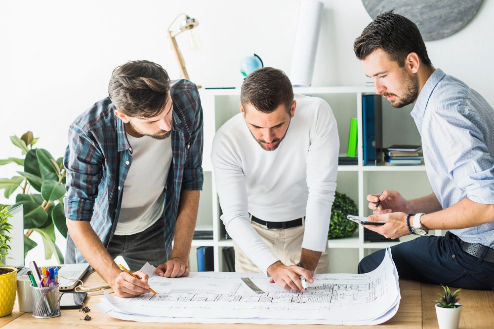 people working on the construction plan